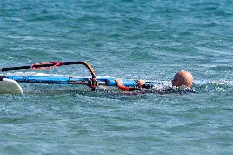 Swimming backwards towards the wind helps both you and the wind clear the sail for the 'airplane' method