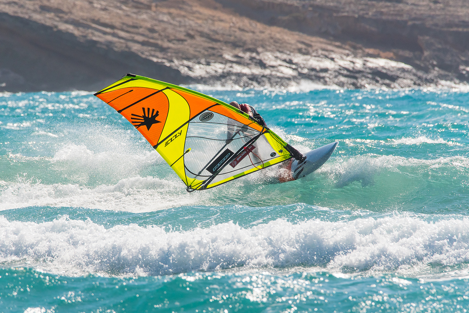 Continue to push out on your back hand and aim to turn your head more. Push through your front foot and pull through your back foot to scissor, steer and turn the board back down the wave.