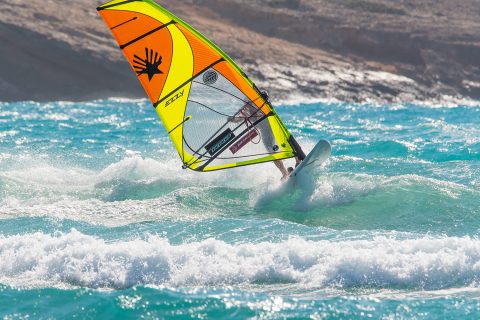 As you drop down the wave, keep the sail sheeted out and your back leg bent, pulling the tail underneath you. You then have the option to drop down the wave, away from it, and do another backside turn, or carry on along the wave ‘beach bound’, or set up for a frontside turn.