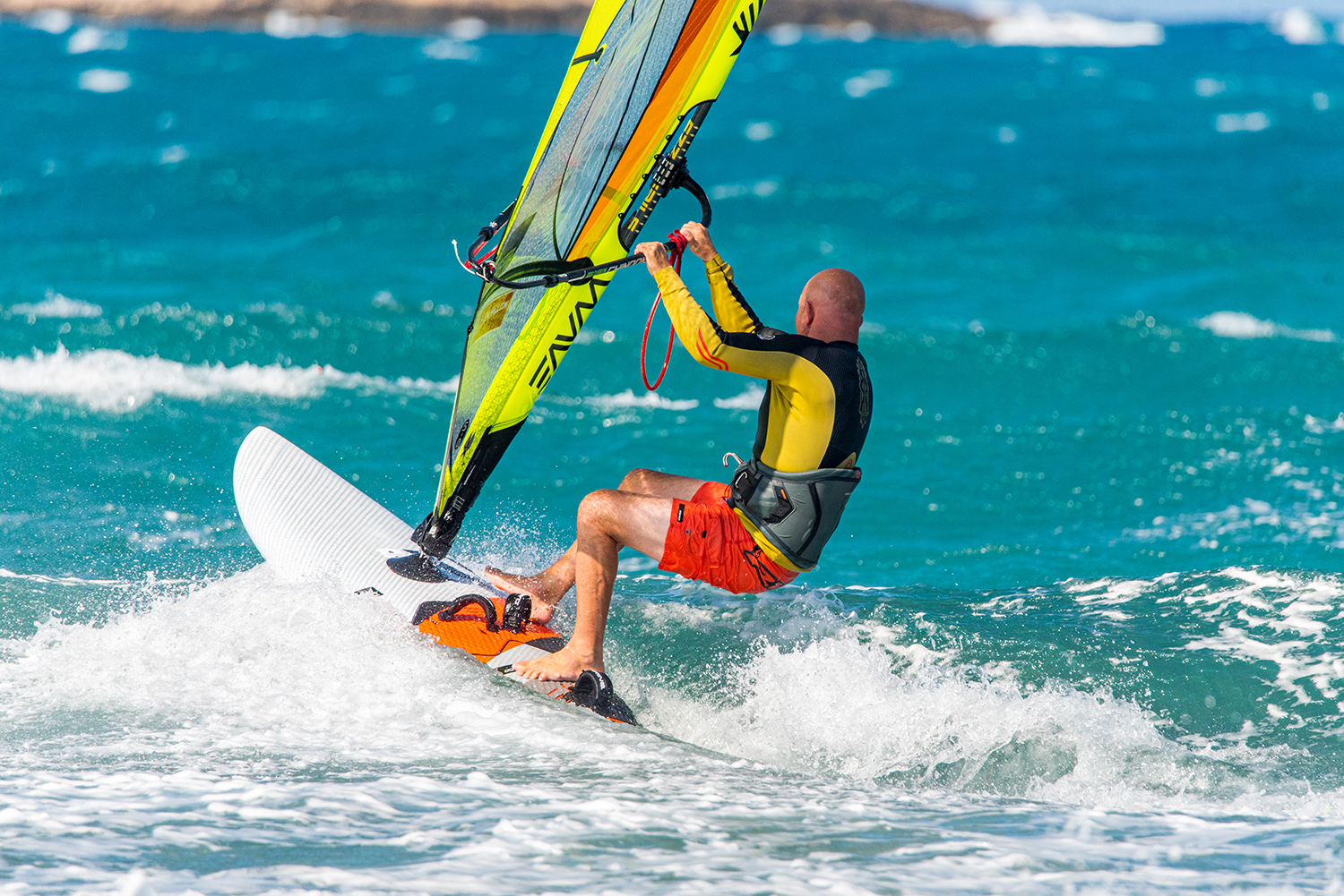 Keep low out of your gybes in the waves and get into the front strap, before hooking in, to avoid crashes and get up to speed quicker.