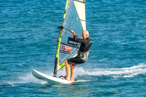 Back foot comes out and goes right next to the back strap and well over the rail. Sheeting in here will bring you over the board and dump some sail power. Start to weight the tail to lift the nose, as well as lifting up on the front foot and arm.