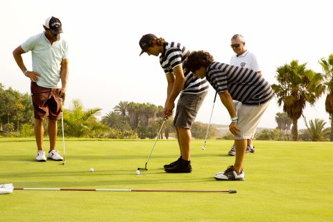 Many sailors are golfers when it is not windy! Victor Fernandez goes for the put as Alex Mussolini looks on!