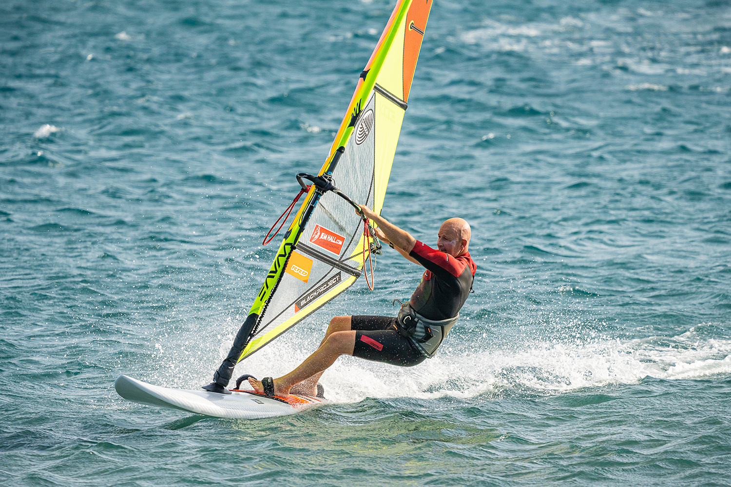 Back hand back, then unhook and then get the back foot out of the footstrap in order to put more precision into your gybe preparation.