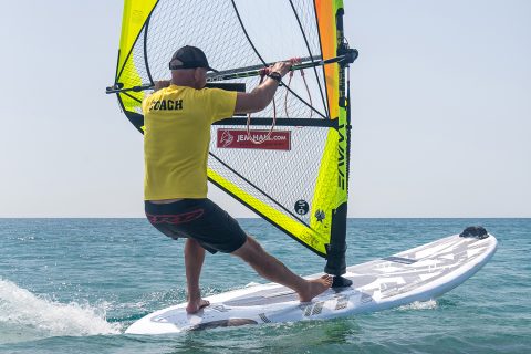 Set up across the wind with your hands back, and back foot way back. Turn downwind by getting the rig forwards and across you, whilst your legs scissor hard, front foot pushing and back foot really pulling. Being back and out puts you in a strong position.