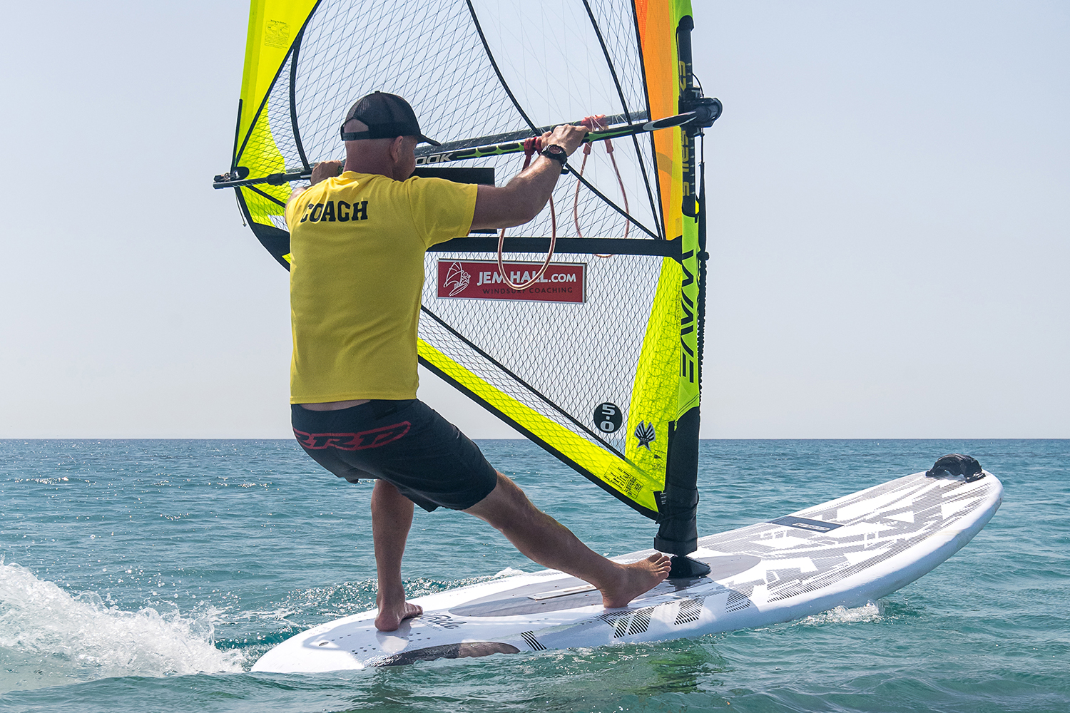Set up across the wind with your hands back, and back foot way back. Turn downwind by getting the rig forwards and across you, whilst your legs scissor hard, front foot pushing and back foot really pulling. Being back and out puts you in a strong position.