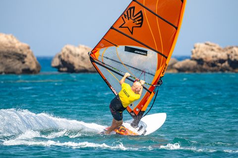 Pulling the rig hard across you, while being patient, means you catch the rig with your hands near the lines, which is a great position to plane out and not oversheet. Spot your exit to keep the board carving and help with the foot change. Note: Your arms should be more extended than mine are here!