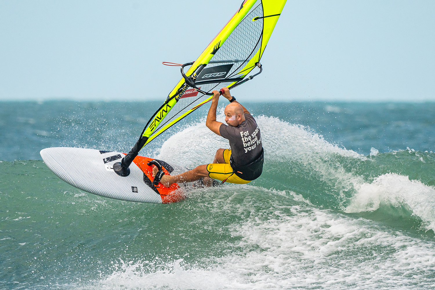 Look out of your top turn and slide that back hand up the boom, as you shift your hips outboard.