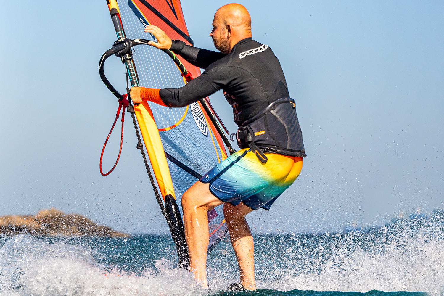 Now you can look to the new side of the boom in readiness to place your hand on it. The hand moves just before the foot change, this will help you throw the rig forwards fast and early after your foot change.