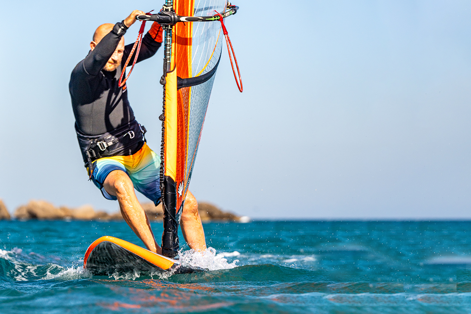 Precision; with the hands it is about having your backhand by the back line on the entrance and your front hand low on the mast. Having your front foot forward and on the mastfoot helps your footwork, and helps prevent the nose sinking, which will then help you get your back foot back past the rear footstrap.