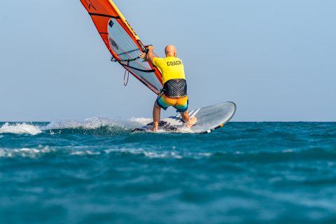 Slide that mast hand to the front of the boom, look forward, be out and low.