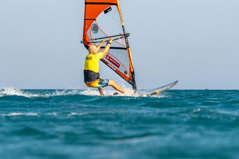 Drive the rig forward and get your hands next to the lines as you pull down on the boom and push the board forward through a straight front leg and bent back leg.