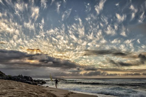 The sun goes down behind the West Maui's